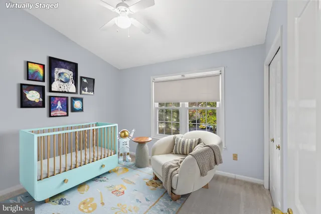 a bedroom with furniture and a large window