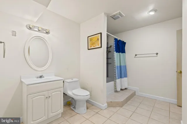 a bathroom with a toilet a sink and a mirror