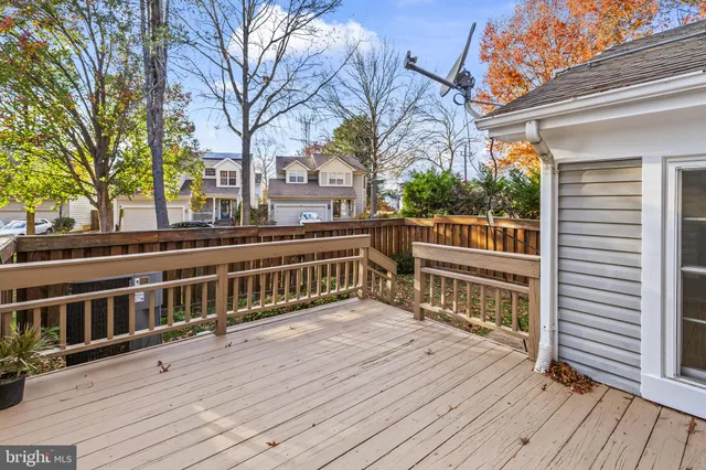 a view of a deck with two chairs and wooden floor