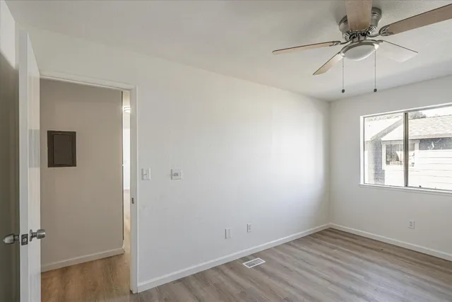 wooden floor in an empty room with a window