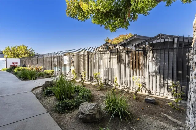 a view of a street with a bench and some trees