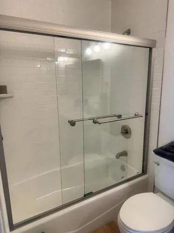 a bathroom with a shower and toilet