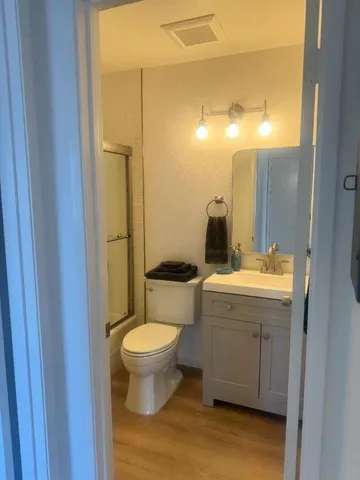 a bathroom with a sink toilet and shower