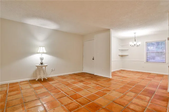 a bedroom with a bed and a lamp on table