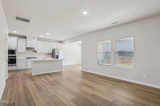 a kitchen with stainless steel appliances a refrigerator sink and stove