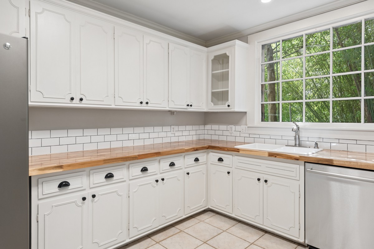 1300 Riverside Road Old Hickory, TN 37138 - Photo 12 of 40 a kitchen with granite countertop white cabinets and sink