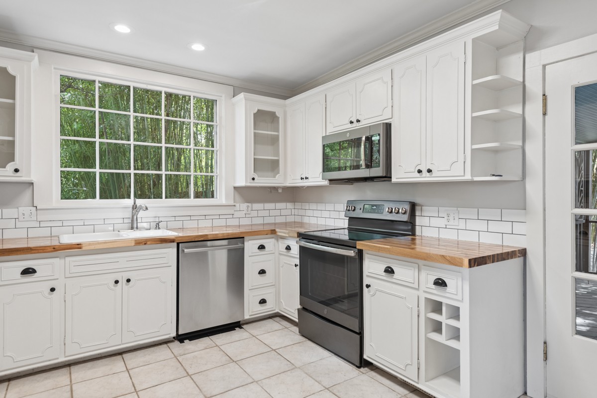 1300 Riverside Road Old Hickory, TN 37138 - Photo 13 of 40 a kitchen with stainless steel appliances granite countertop a stove a sink and a microwave