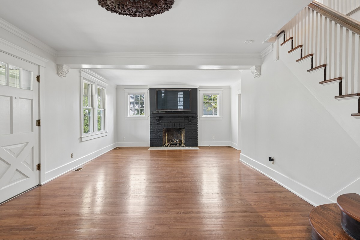 1300 Riverside Road Old Hickory, TN 37138 - Photo 5 of 40 a view of an empty room with wooden floor fireplace and a window