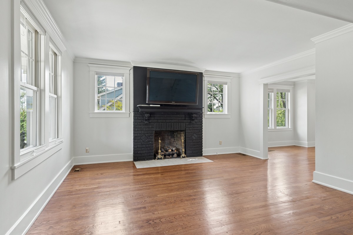 1300 Riverside Road Old Hickory, TN 37138 - Photo 6 of 40 an empty room with windows a fireplace and wooden floor