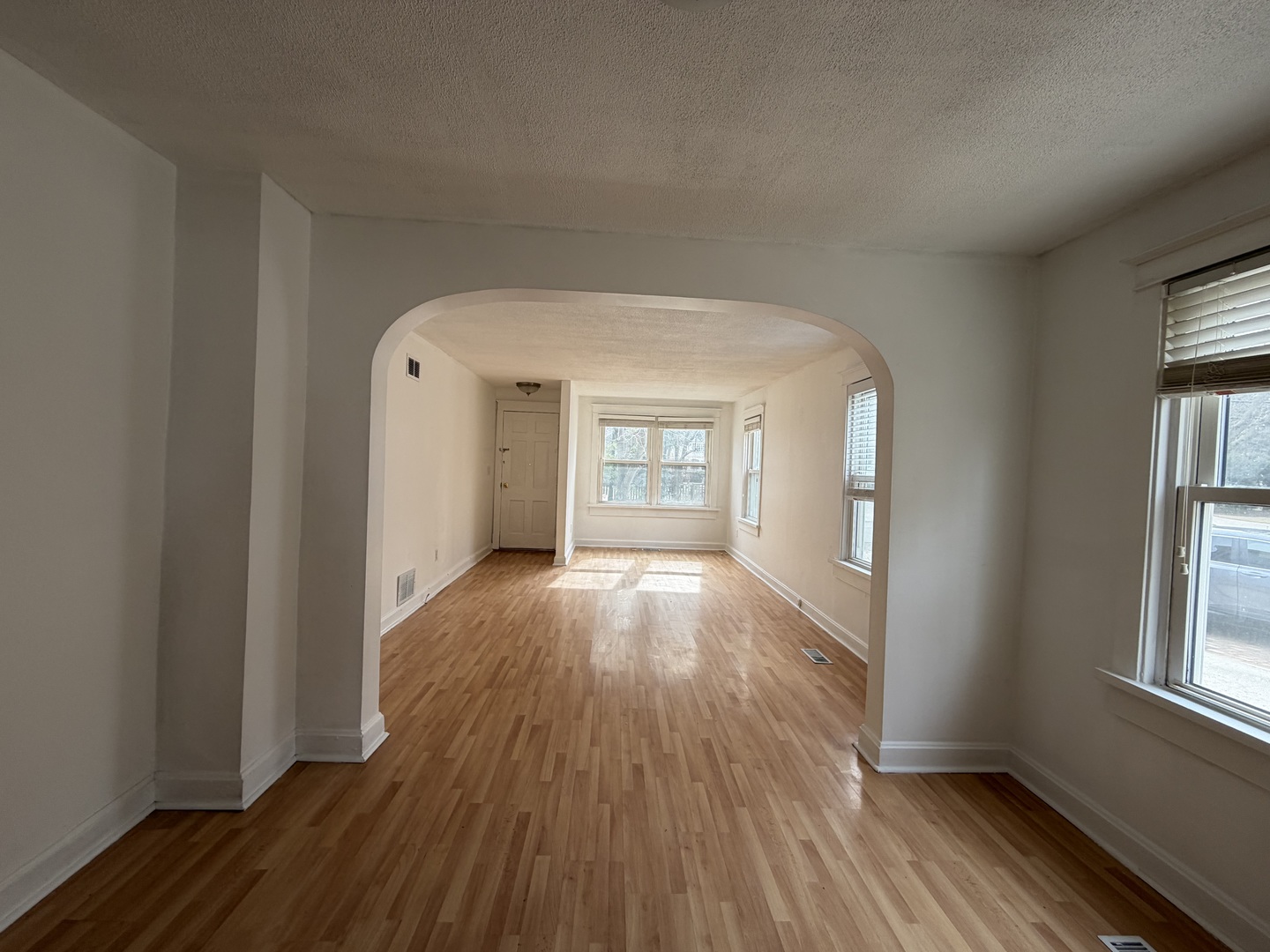 215 Fuller Road Hinsdale, IL 60521 - Photo 2 of 10 an empty room with wooden floor and windows