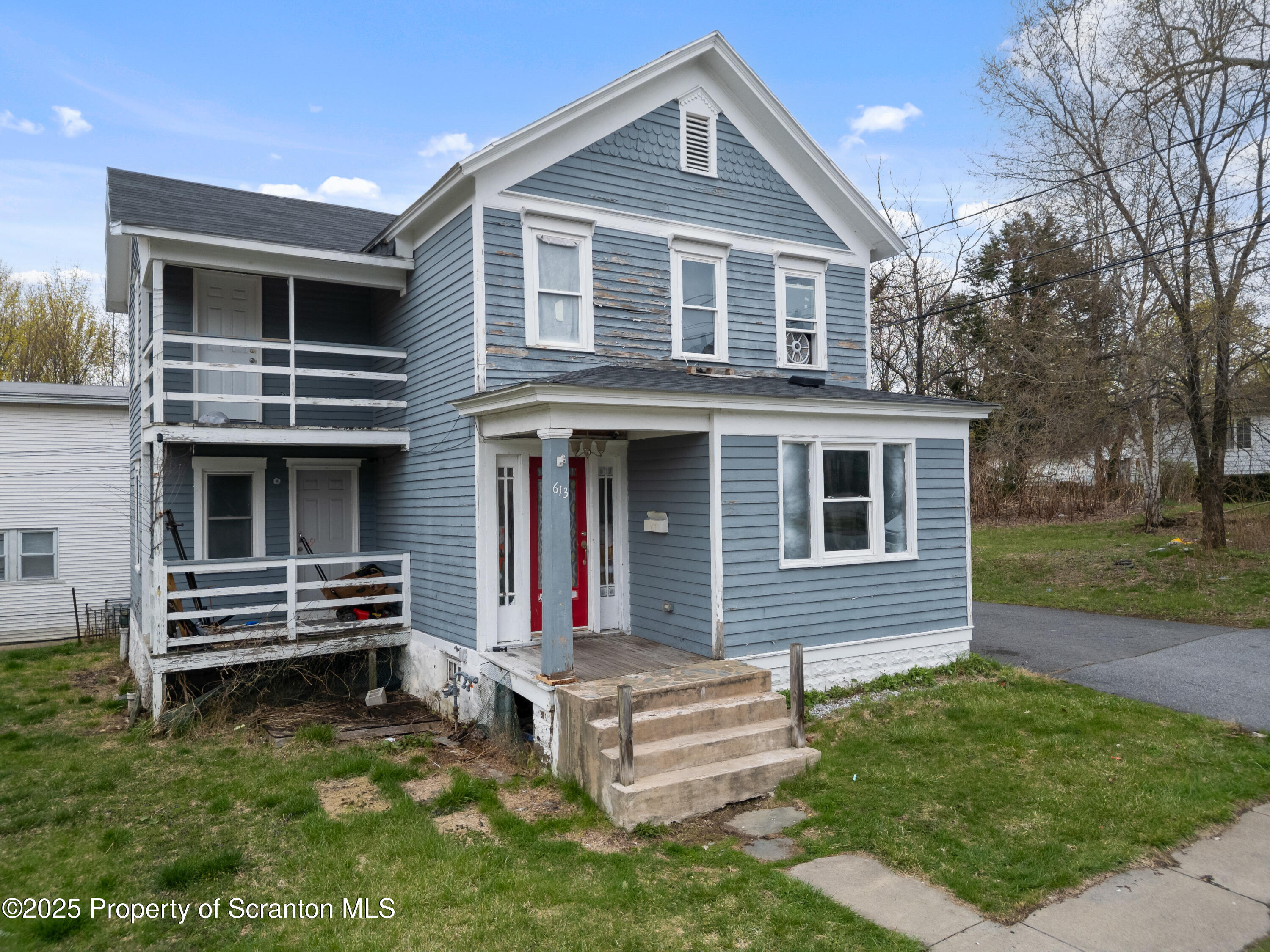 613 East Locust Street Scranton, PA 18505 - Photo 1 of 20 a front view of a house with a yard