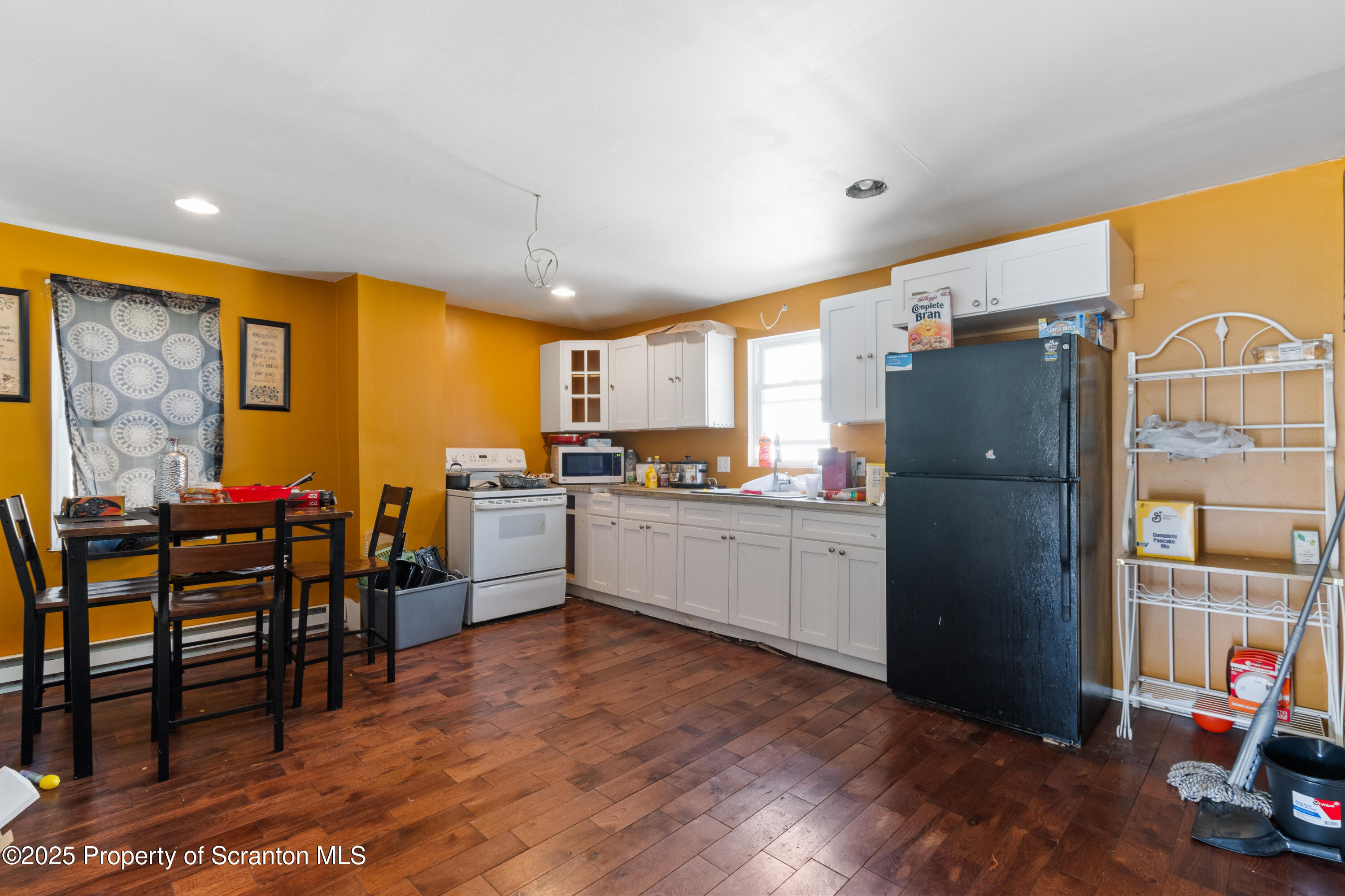 613 East Locust Street Scranton, PA 18505 - Photo 11 of 20 a kitchen with stainless steel appliances wooden cabinets and dining table view