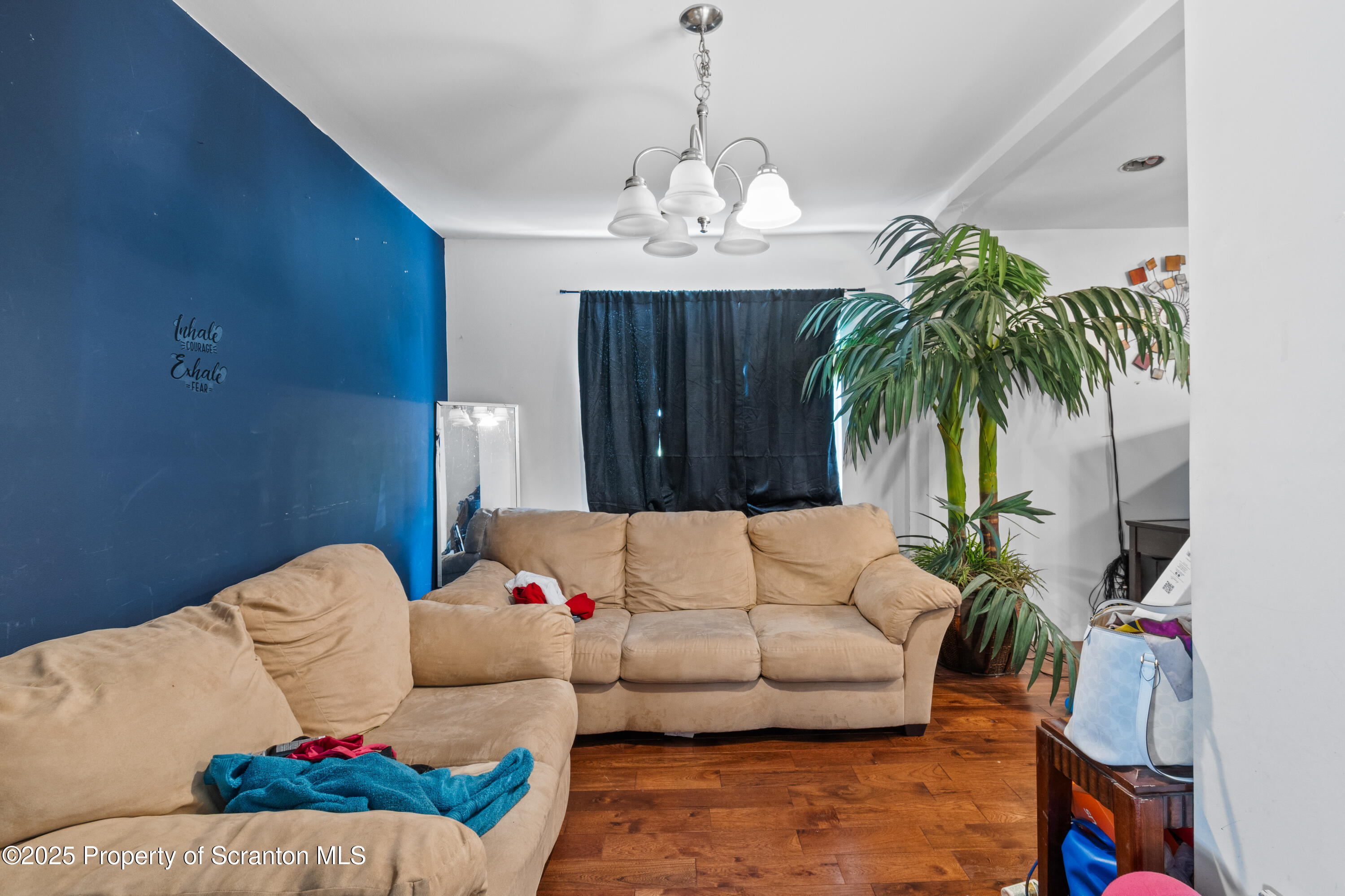 613 East Locust Street Scranton, PA 18505 - Photo 12 of 20 a living room with furniture and a chandelier