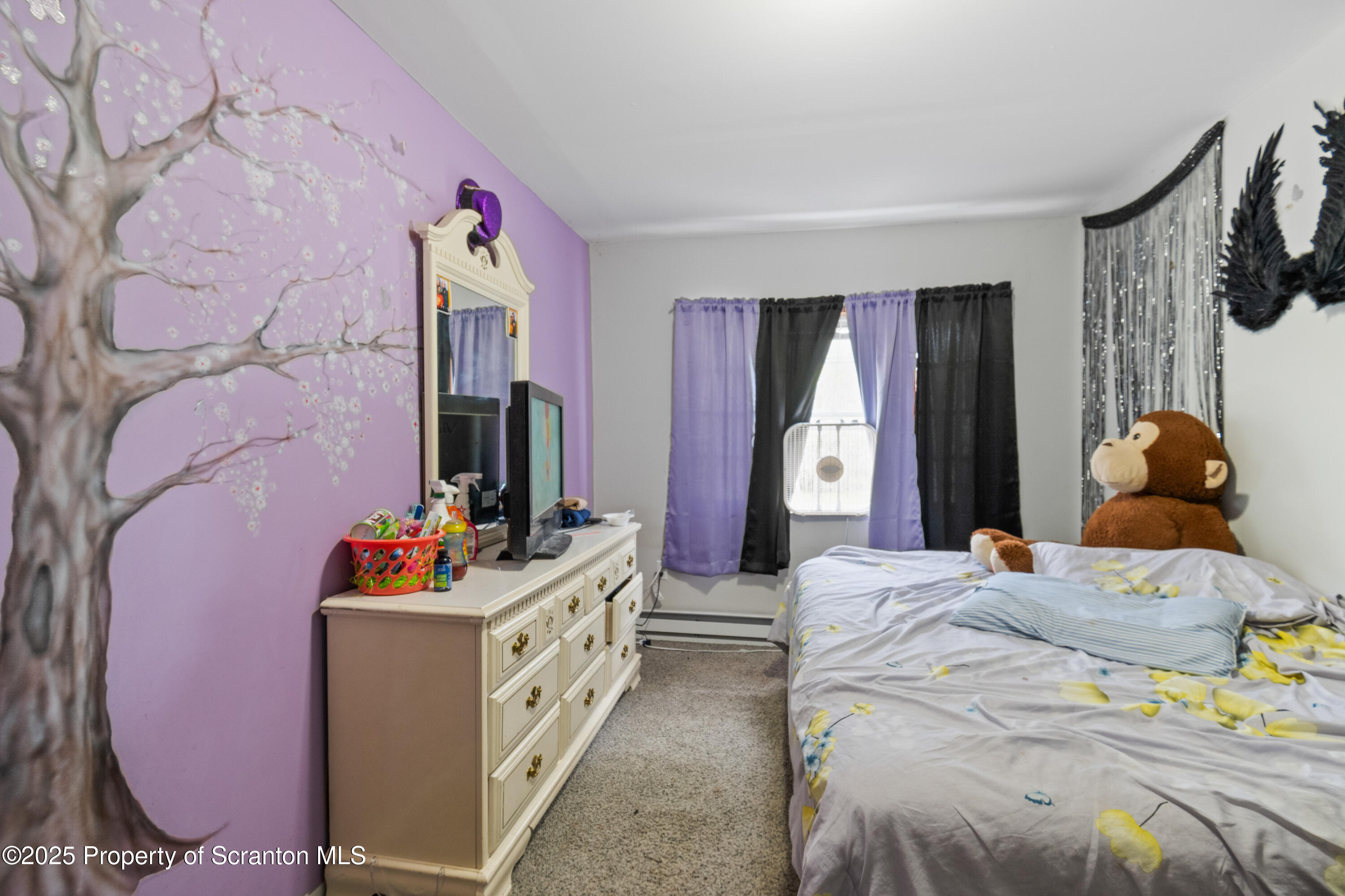 613 East Locust Street Scranton, PA 18505 - Photo 16 of 20 a bedroom with a bed and dresser with mirror