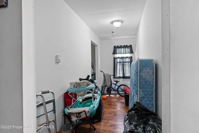 a living room with furniture and a book shelf