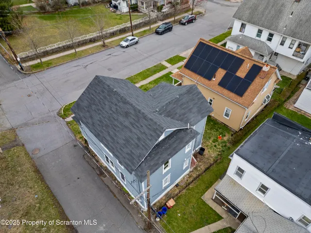 an aerial view of a house with a swimming pool
