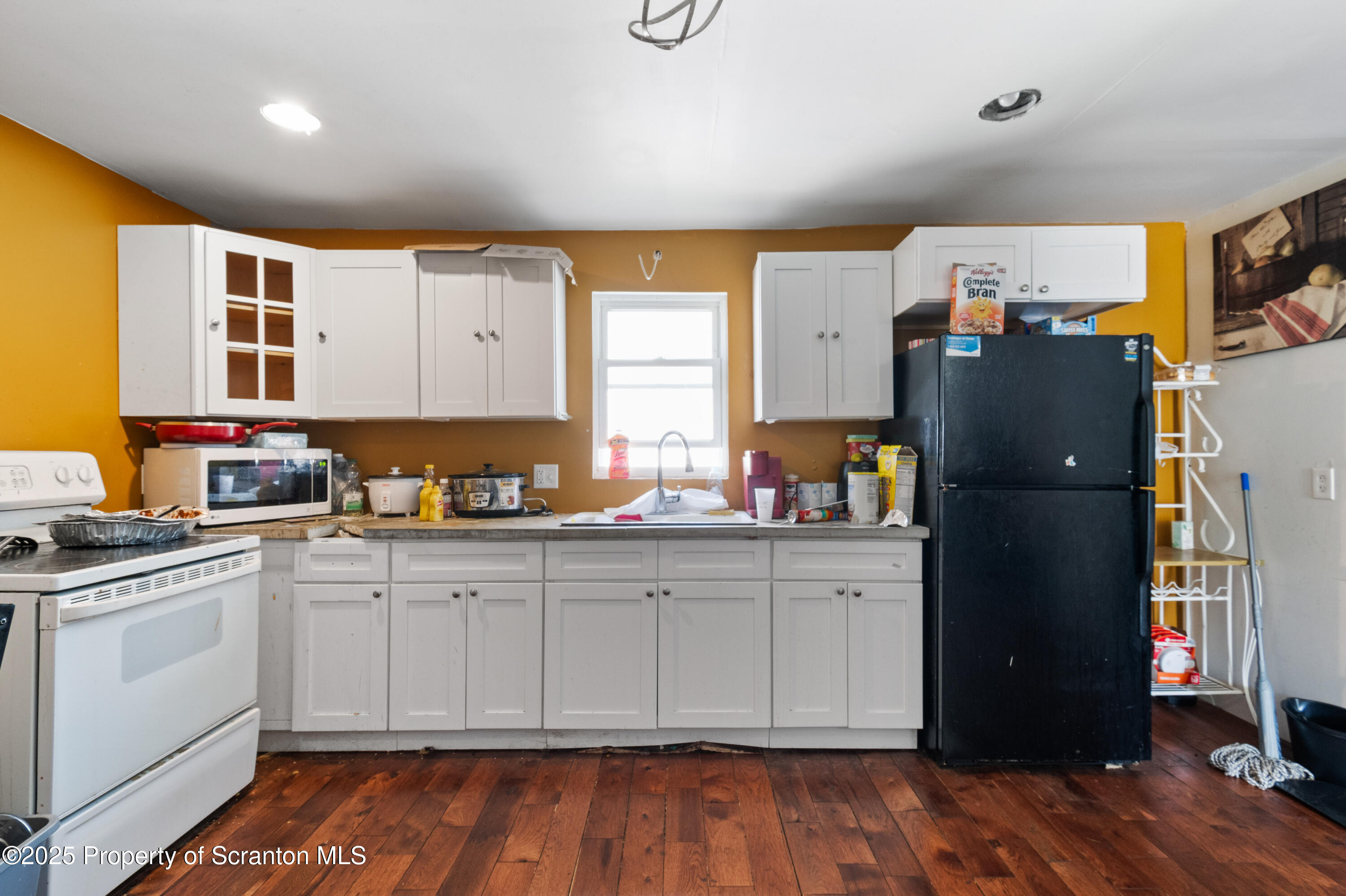 613 East Locust Street Scranton, PA 18505 - Photo 6 of 20 a kitchen with stainless steel appliances granite countertop a refrigerator and a stove top oven