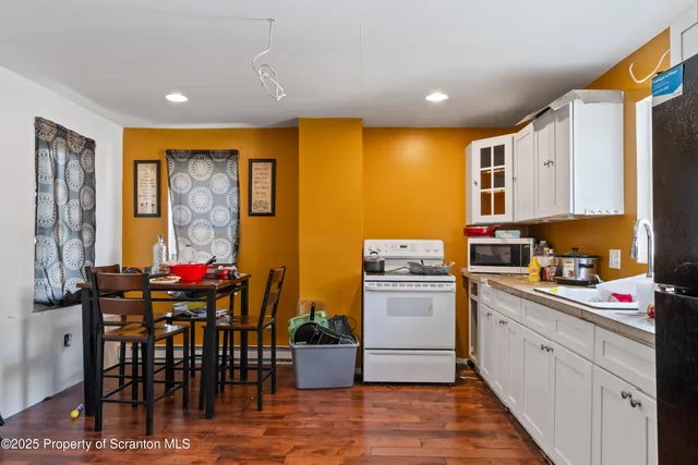 a kitchen that has a lot of cabinets in it and appliances