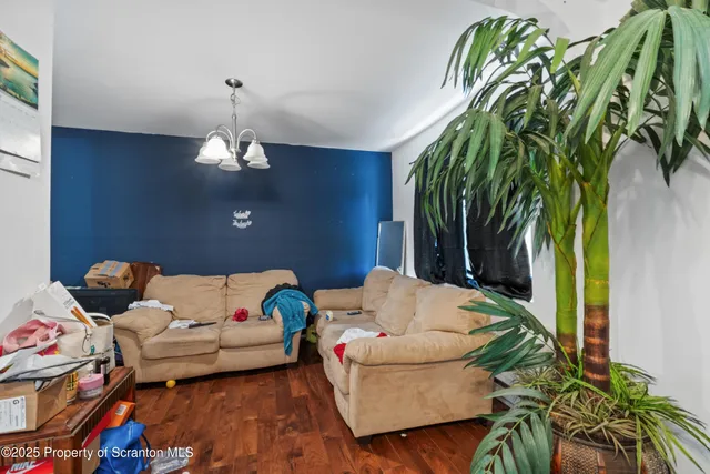 a living room with furniture and a chandelier