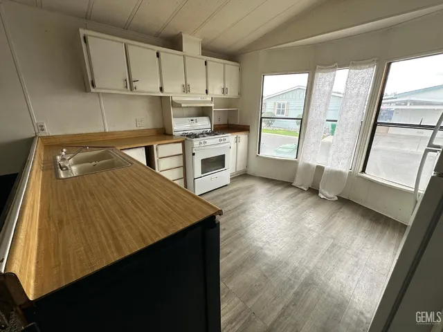 a kitchen with a refrigerator and window