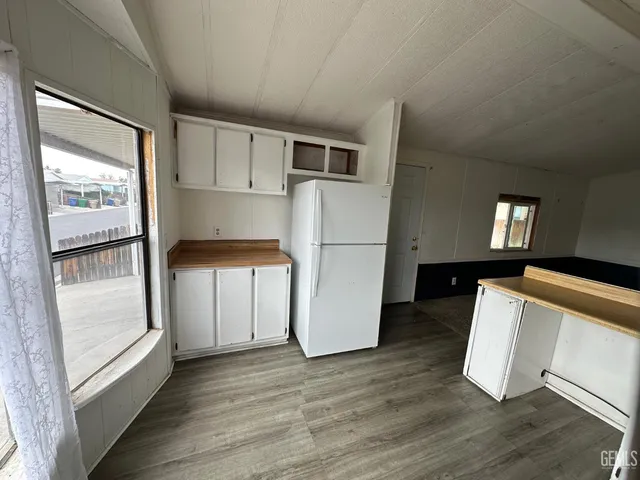 a kitchen with a refrigerator and a stove