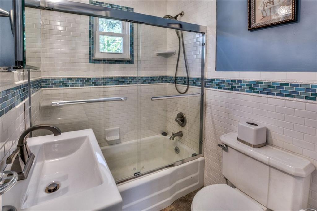 220 Fox Chapel Road Pittsburgh, PA 15238 - Photo 7 of 14 The updated bath is light and bright with white subway tile.