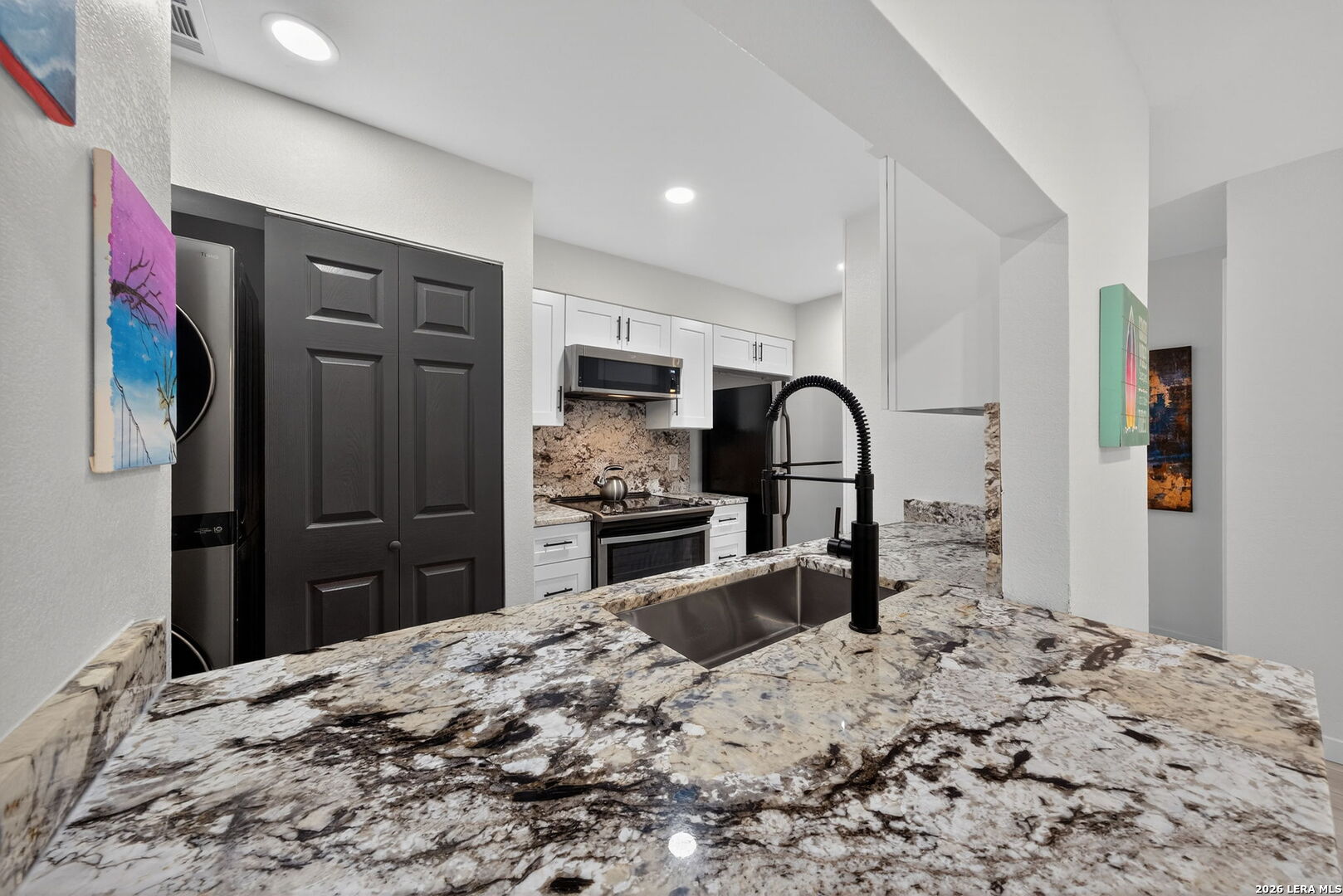 a kitchen with a refrigerator stove and a sink