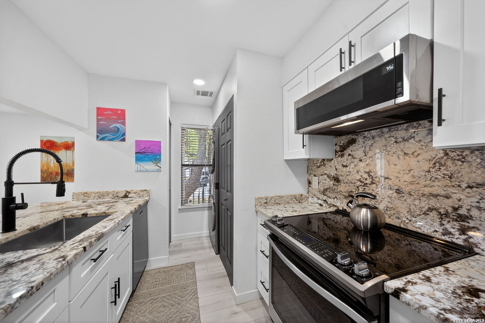 11520 Huebner Road, Unit 501 San Antonio, TX 78230 - Photo 19 of 27 a kitchen with stainless steel appliances granite countertop a stove and a sink