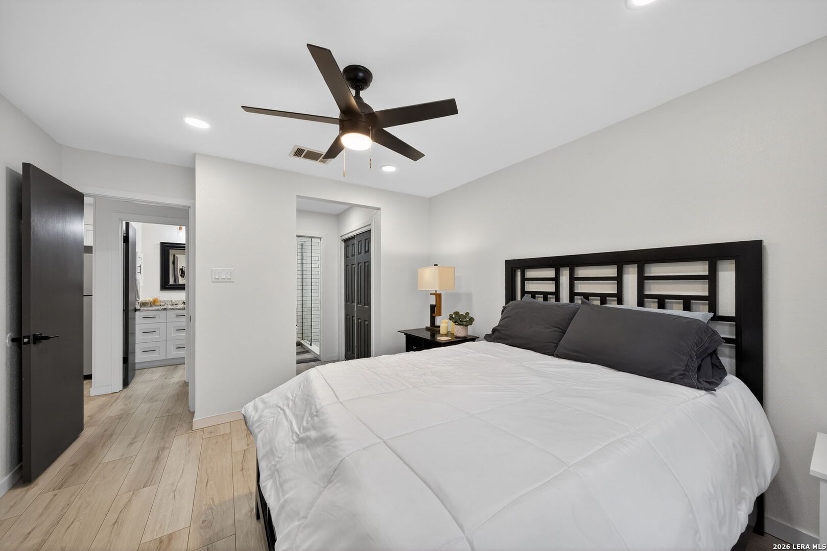 11520 Huebner Road, Unit 501 San Antonio, TX 78230 - Photo 2 of 27 a bedroom with a large bed and a chandelier