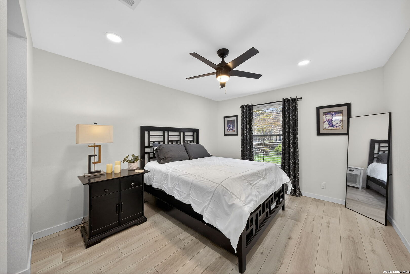 11520 Huebner Road, Unit 501 San Antonio, TX 78230 - Photo 21 of 27 a bedroom with a bed and a dresser