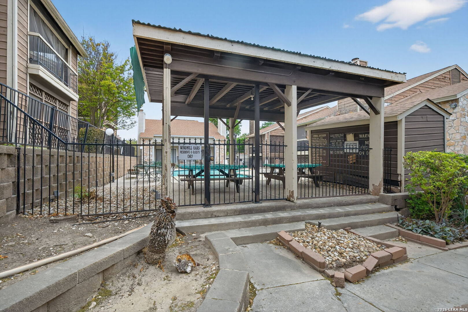 11520 Huebner Road, Unit 501 San Antonio, TX 78230 - Photo 25 of 27 a patio with a table and chairs and potted plants