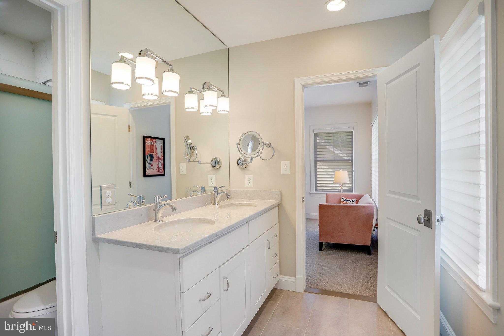 4548 Windsor Lane Bethesda, MD 20814 - Photo 15 of 39 a en suite bathroom with a double vanity sink and a mirror