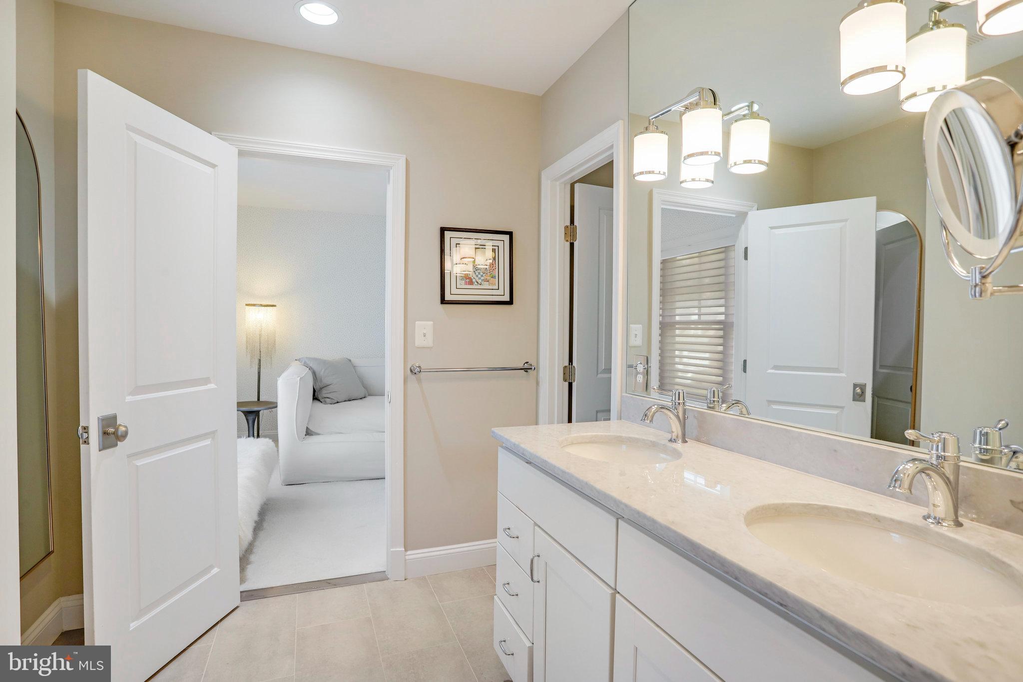 4548 Windsor Lane Bethesda, MD 20814 - Photo 16 of 39 a en suite bathroom with a double vanity sink and a mirror