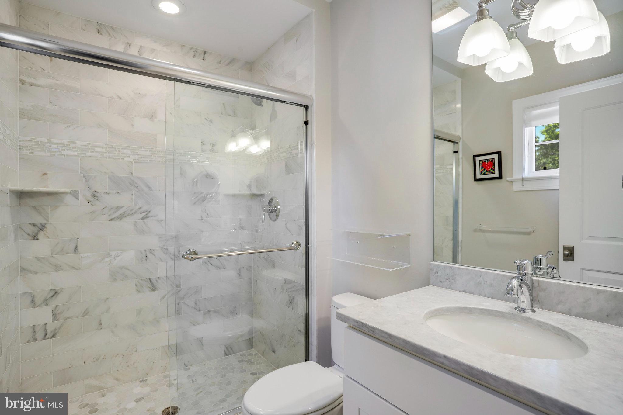 4548 Windsor Lane Bethesda, MD 20814 - Photo 20 of 39 a bathroom with a sink toilet and shower