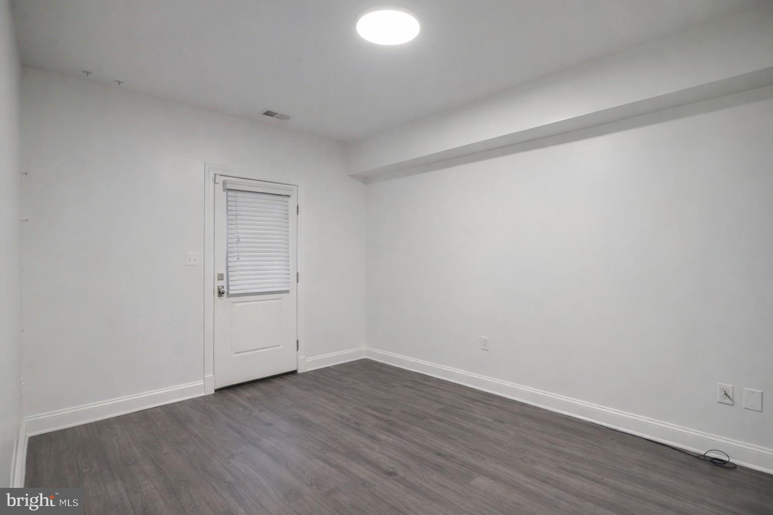 4548 Windsor Lane Bethesda, MD 20814 - Photo 27 of 39 a view of an empty room and wooden floor