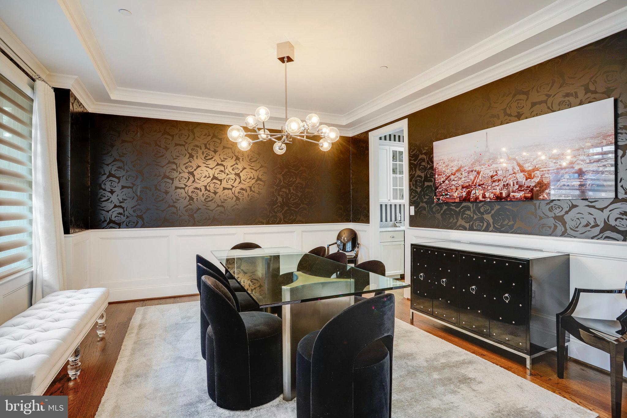 4548 Windsor Lane Bethesda, MD 20814 - Photo 5 of 39 a living room with furniture a flat screen tv and a floor to ceiling window