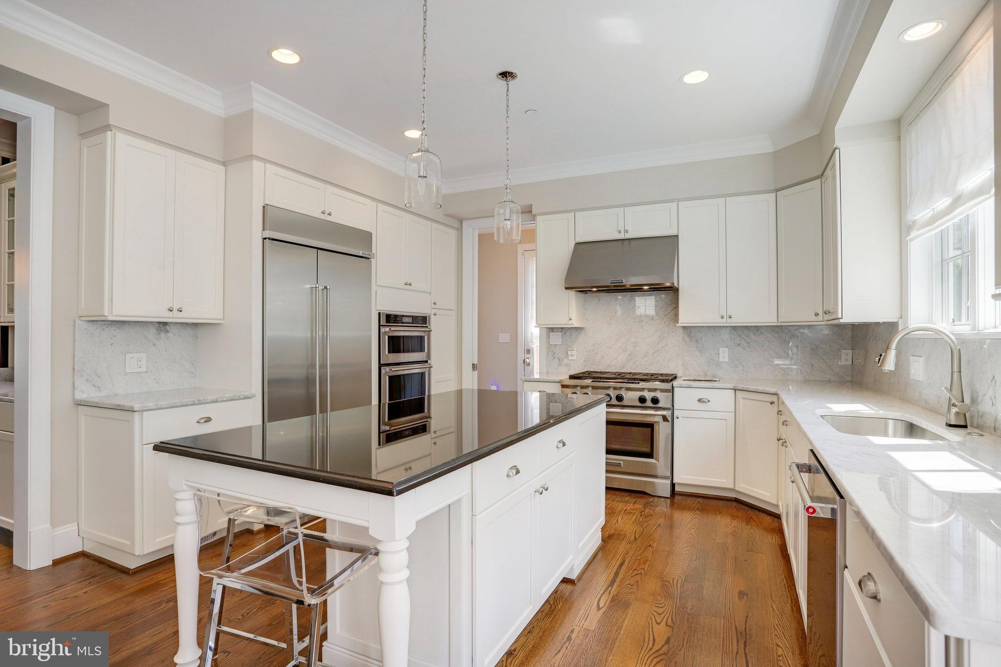 4548 Windsor Lane Bethesda, MD 20814 - Photo 8 of 39 a kitchen with kitchen island a counter top space appliances and cabinets
