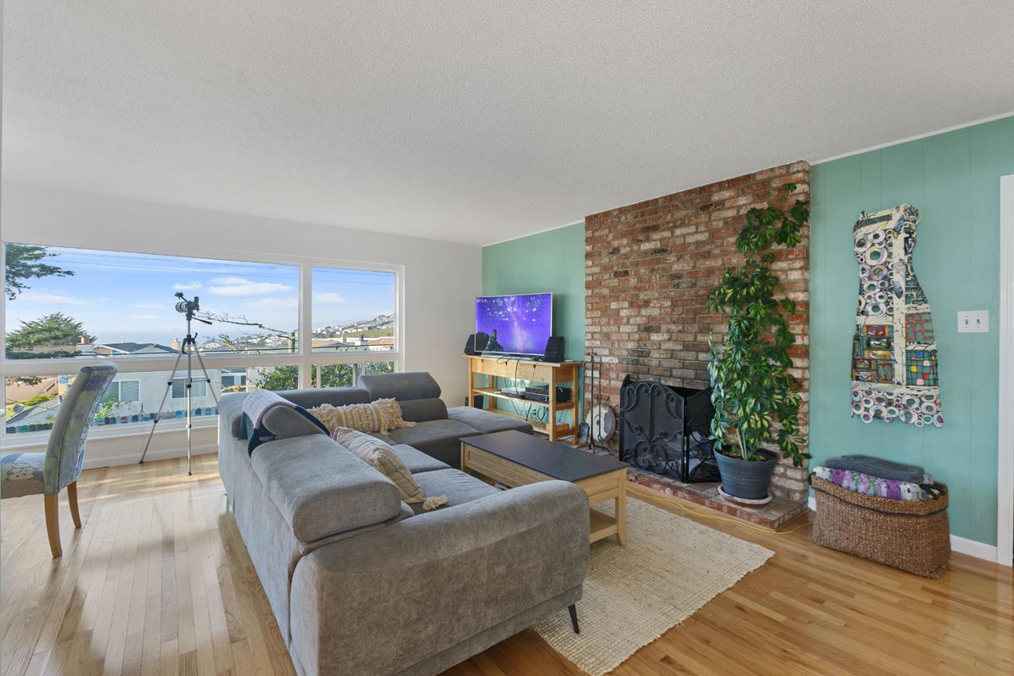 107 Crestmoor Circle Pacifica, CA 94044 - Photo 15 of 45 a living room with furniture potted plant and a fireplace