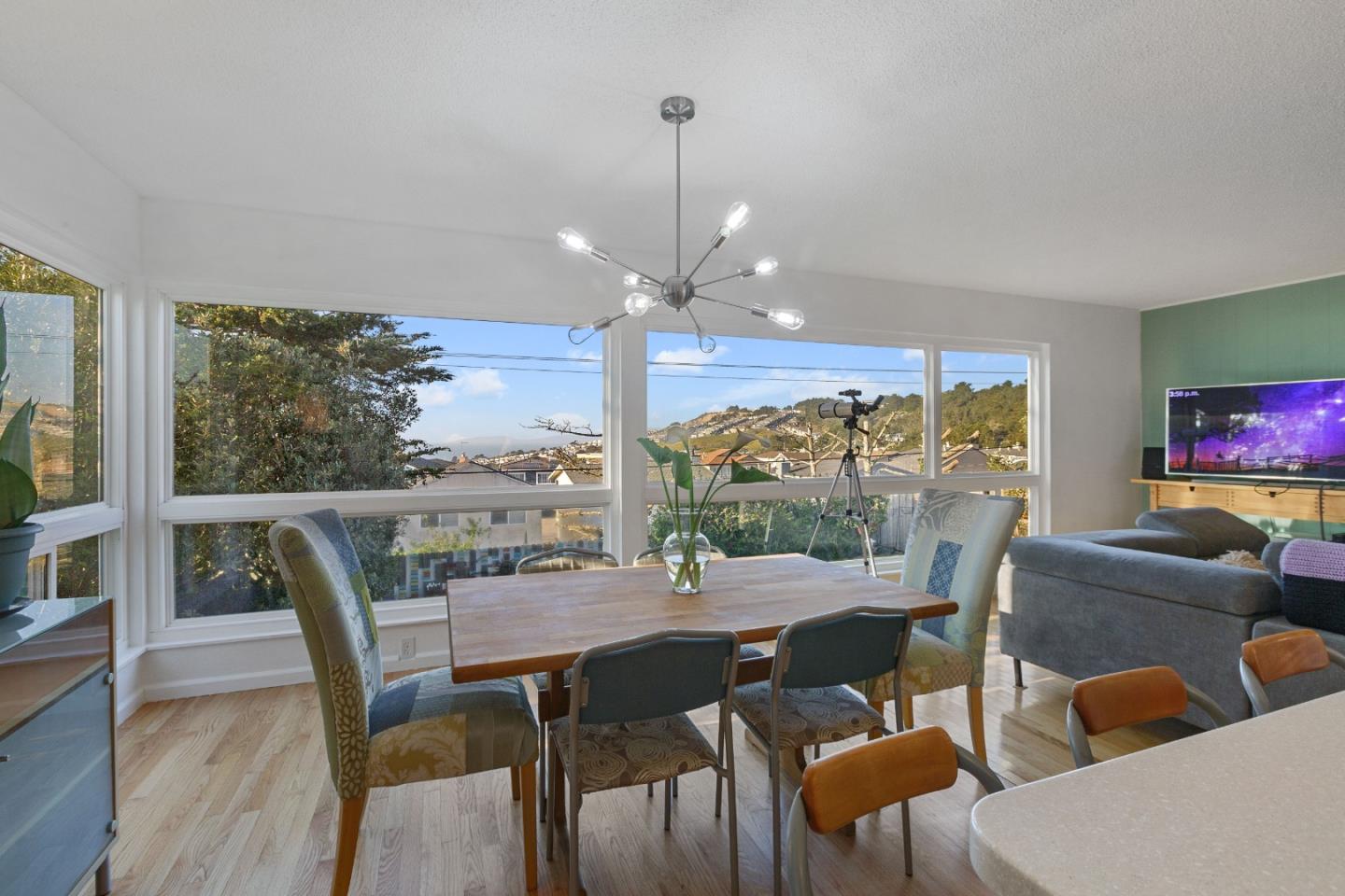 107 Crestmoor Circle Pacifica, CA 94044 - Photo 16 of 45 a view of a dining room with furniture large windows and wooden floor