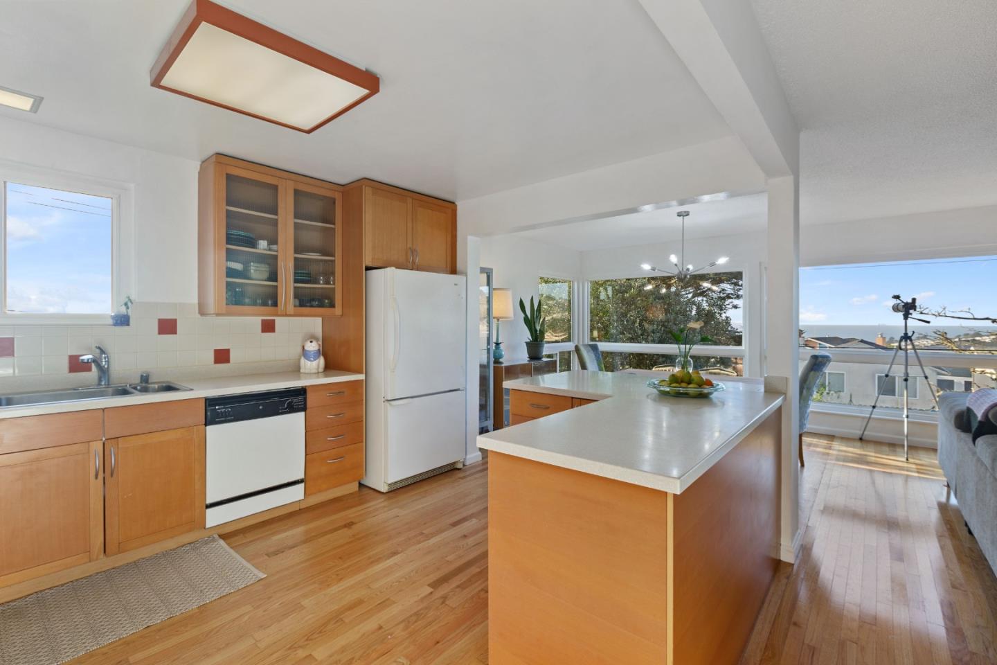 107 Crestmoor Circle Pacifica, CA 94044 - Photo 17 of 45 a kitchen with stainless steel appliances a refrigerator a sink a stove a dining table and chairs