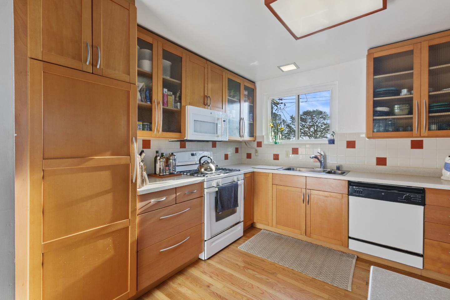 107 Crestmoor Circle Pacifica, CA 94044 - Photo 19 of 45 a kitchen with stainless steel appliances granite countertop a sink and cabinets