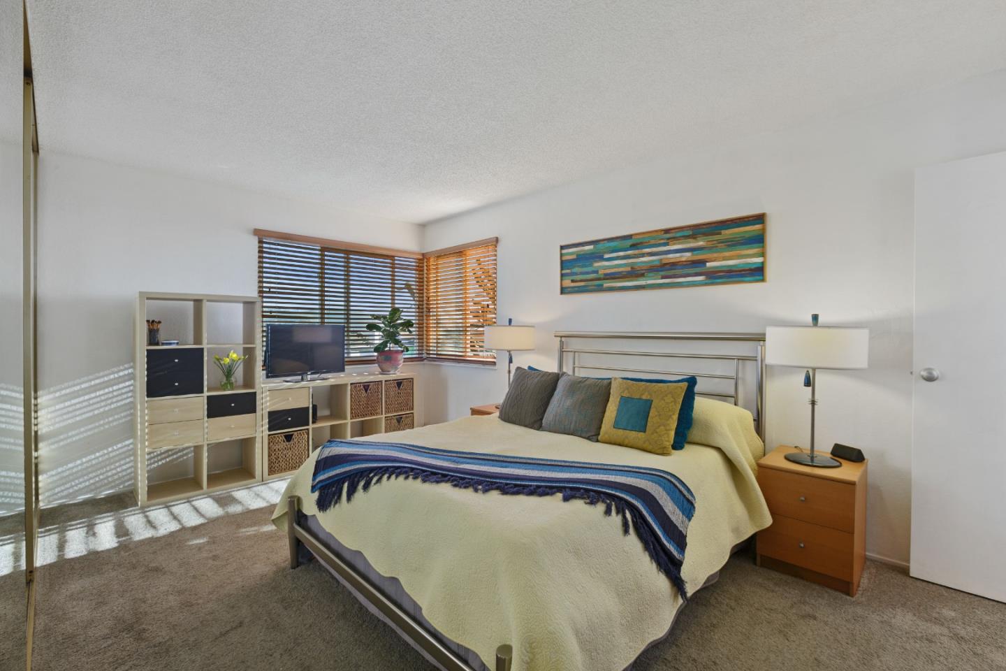 107 Crestmoor Circle Pacifica, CA 94044 - Photo 23 of 45 a bedroom with a bed and wooden floor