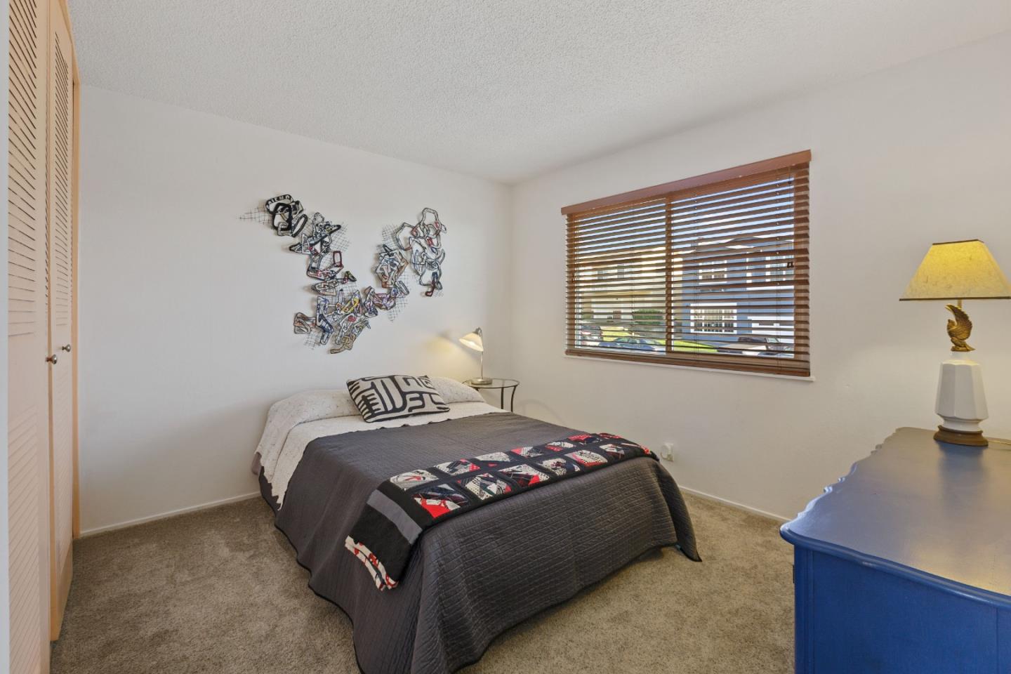 107 Crestmoor Circle Pacifica, CA 94044 - Photo 24 of 45 a bedroom with a bed and a table in it