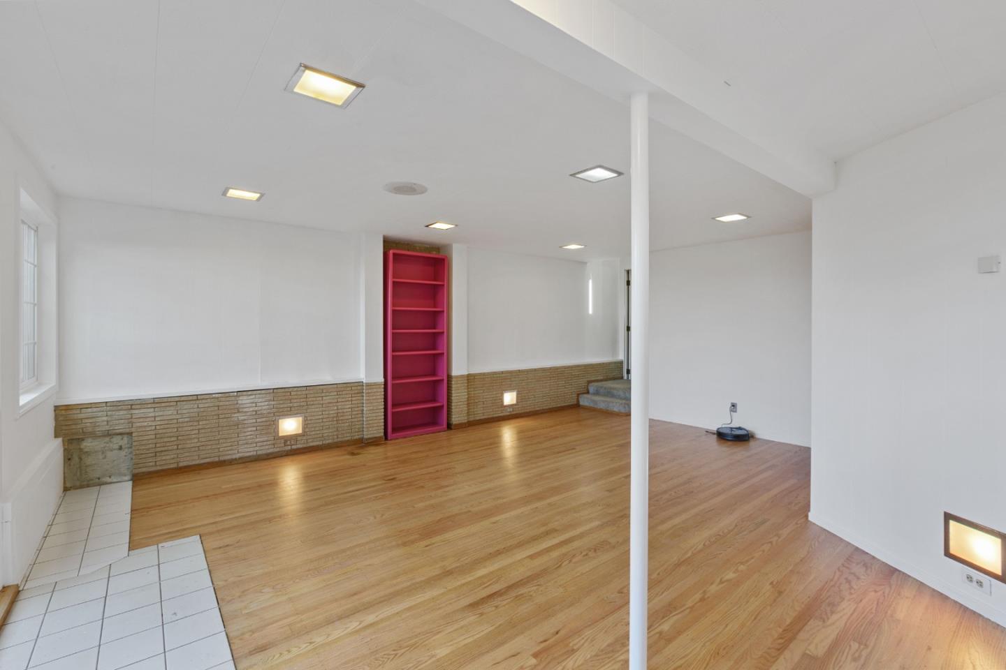 107 Crestmoor Circle Pacifica, CA 94044 - Photo 34 of 45 an empty room with wooden floor and windows
