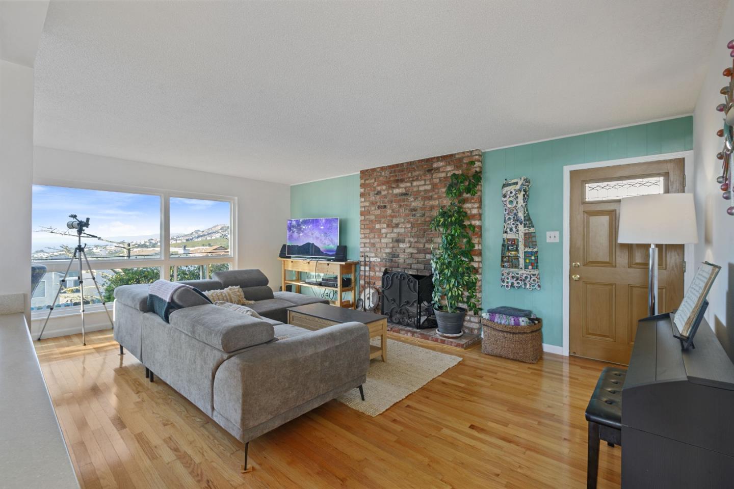 107 Crestmoor Circle Pacifica, CA 94044 - Photo 6 of 45 a living room with fireplace furniture and a large window