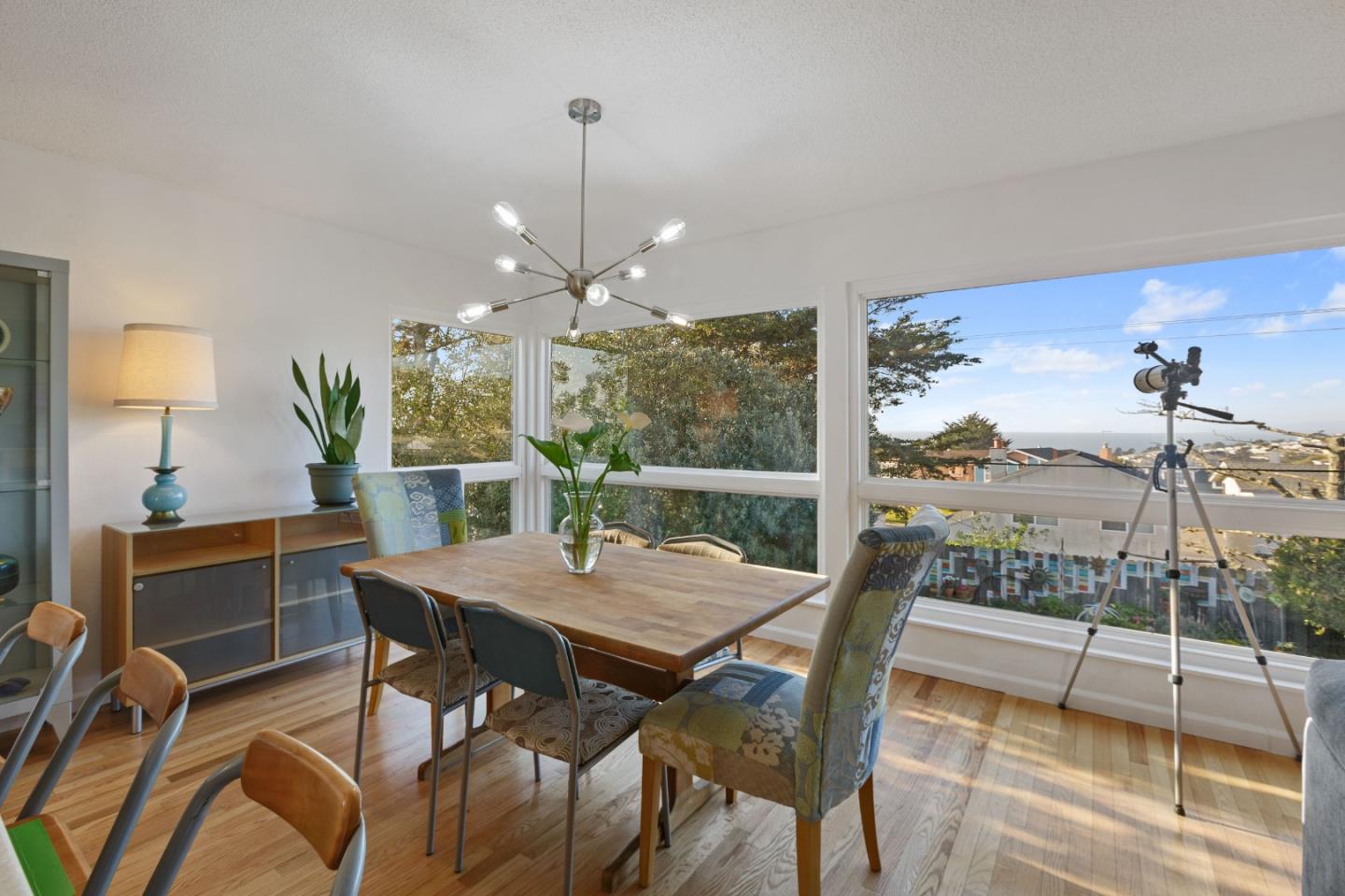 107 Crestmoor Circle Pacifica, CA 94044 - Photo 9 of 45 a view of a dining room with furniture a chandelier and wooden floor
