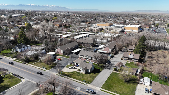 1115 North Main Street Bountiful, UT 84010 - Photo 16 of 17 Aerial perspective showcasing a residential and commercial area with multiple properties, a prominent roadway, and distant mountains