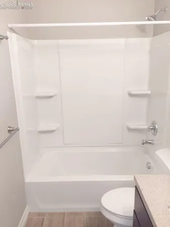 a bathroom with a sink a toilet and bathtub