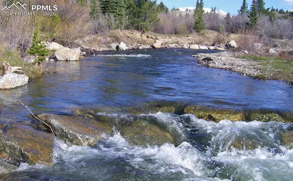 a view of a lake with a yard