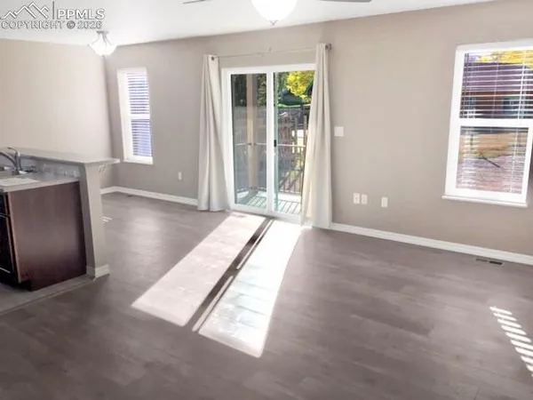 an empty room with windows and closet